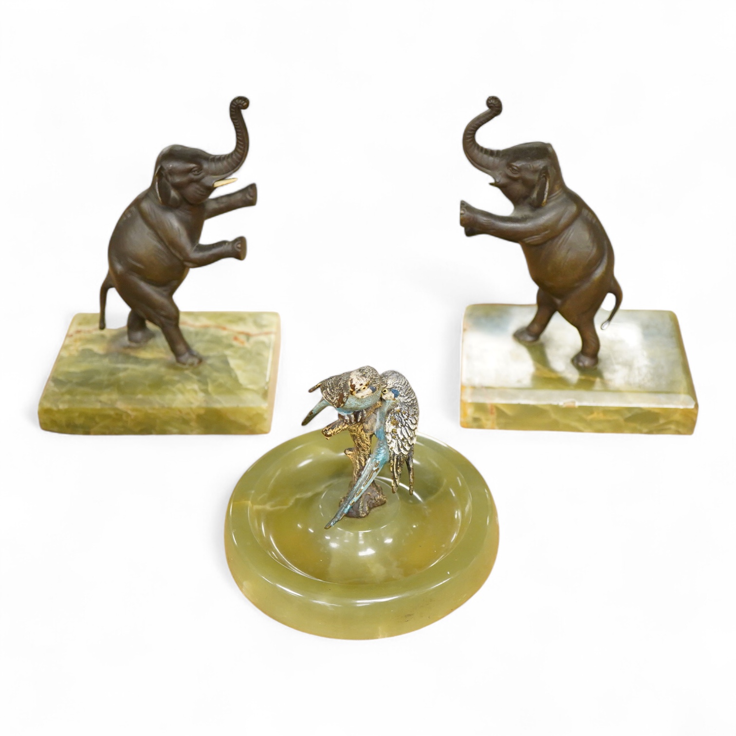 Two Art Deco bronze elephants and a cold painted bronze parakeet group, all on green onyx bases, tallest 17cm